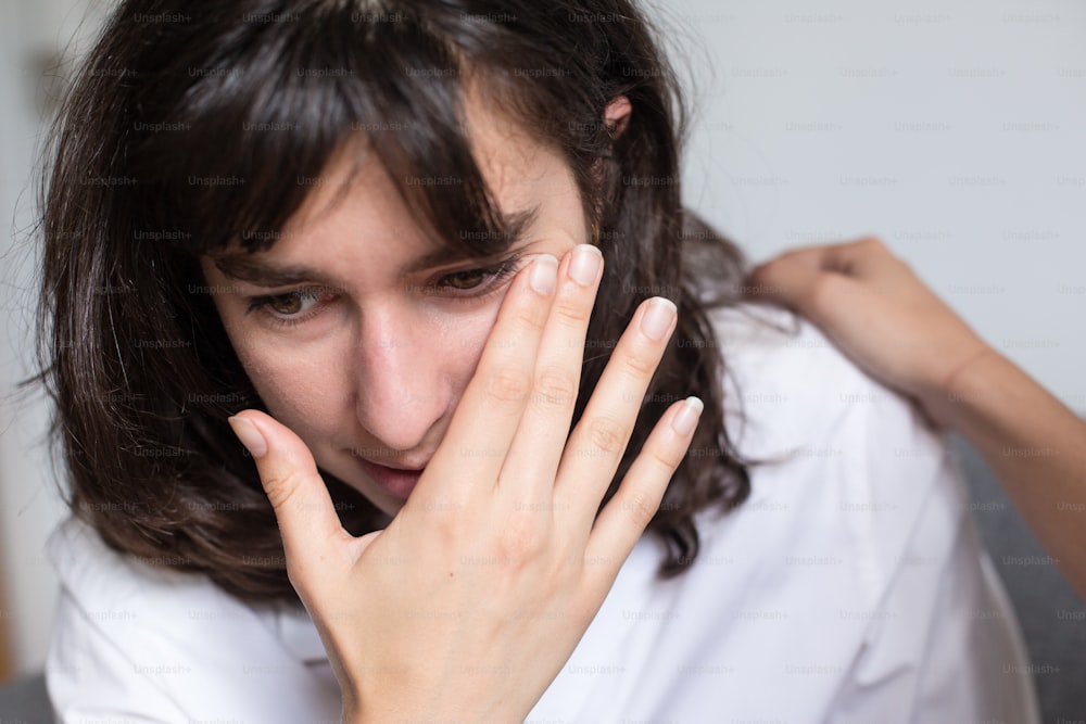 a woman holding her hands to her face