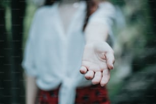 a close up of a person holding out their hand