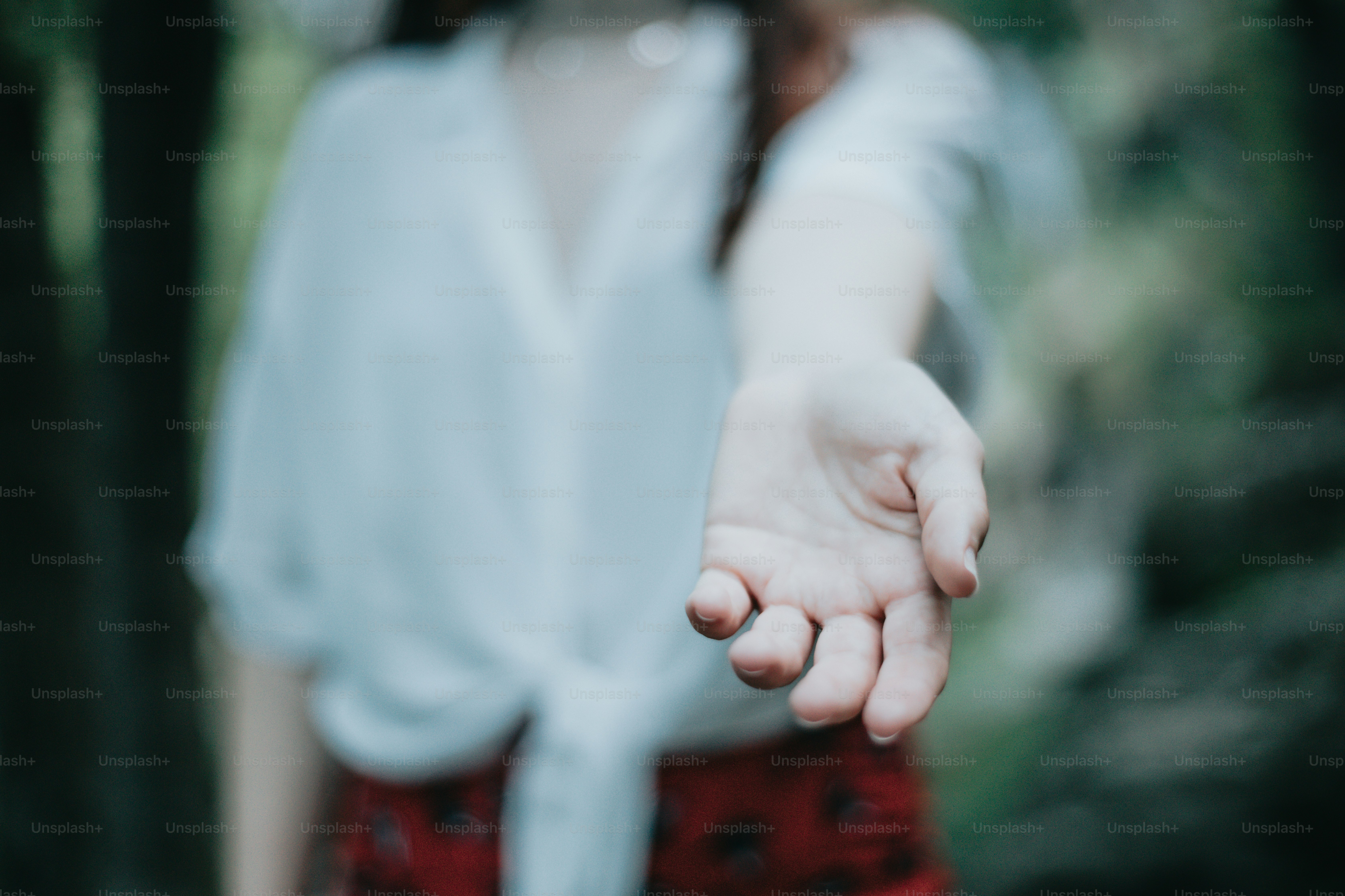 a close up of a person holding out their hand