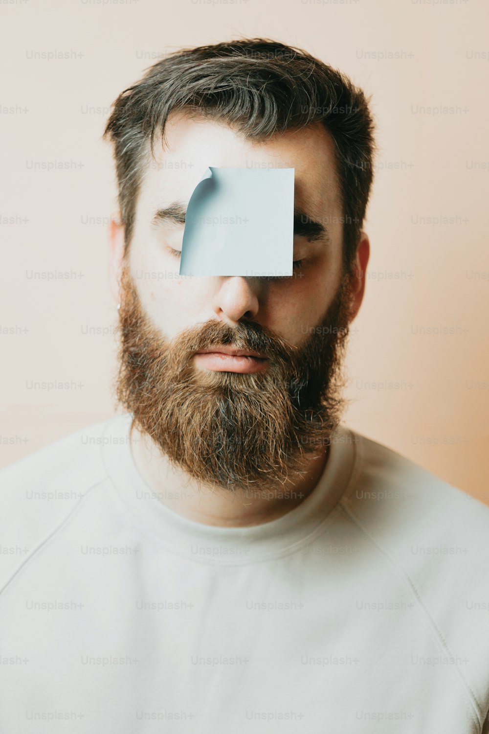 a man with a piece of paper on his face