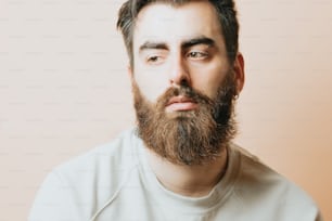 a man with a beard and a white shirt