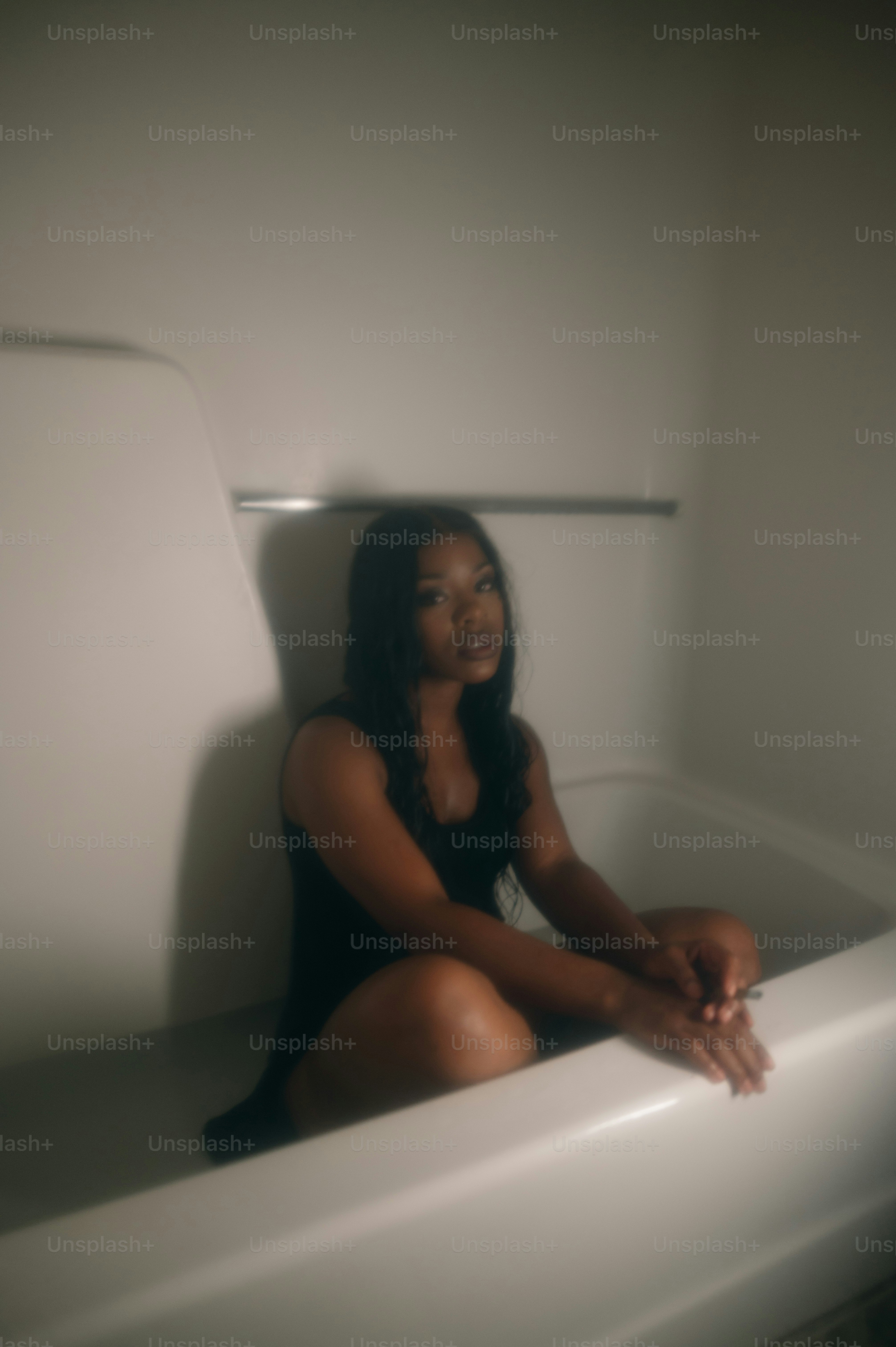 a woman sitting in a bathtub in a bathroom