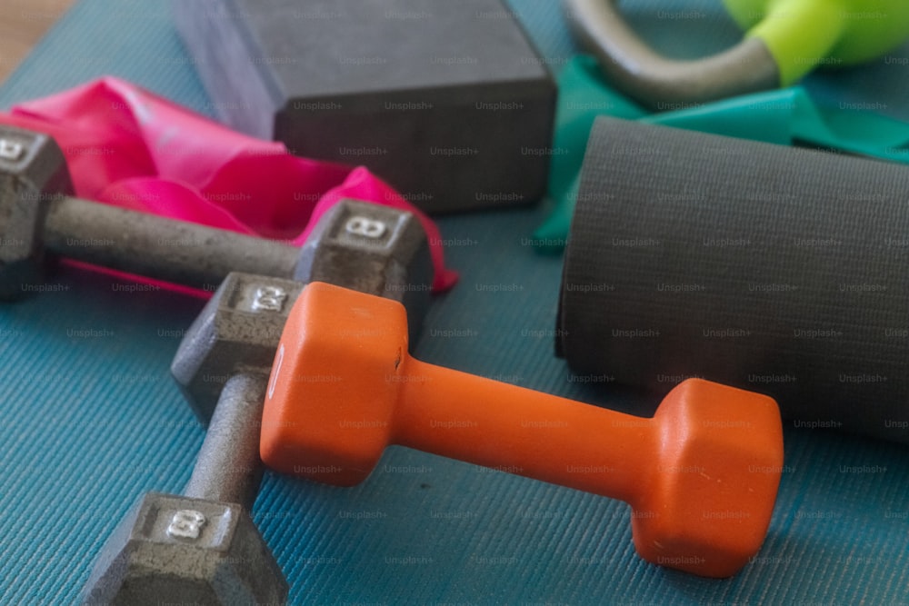 a close up of a gym mat with dumbs and exercise equipment