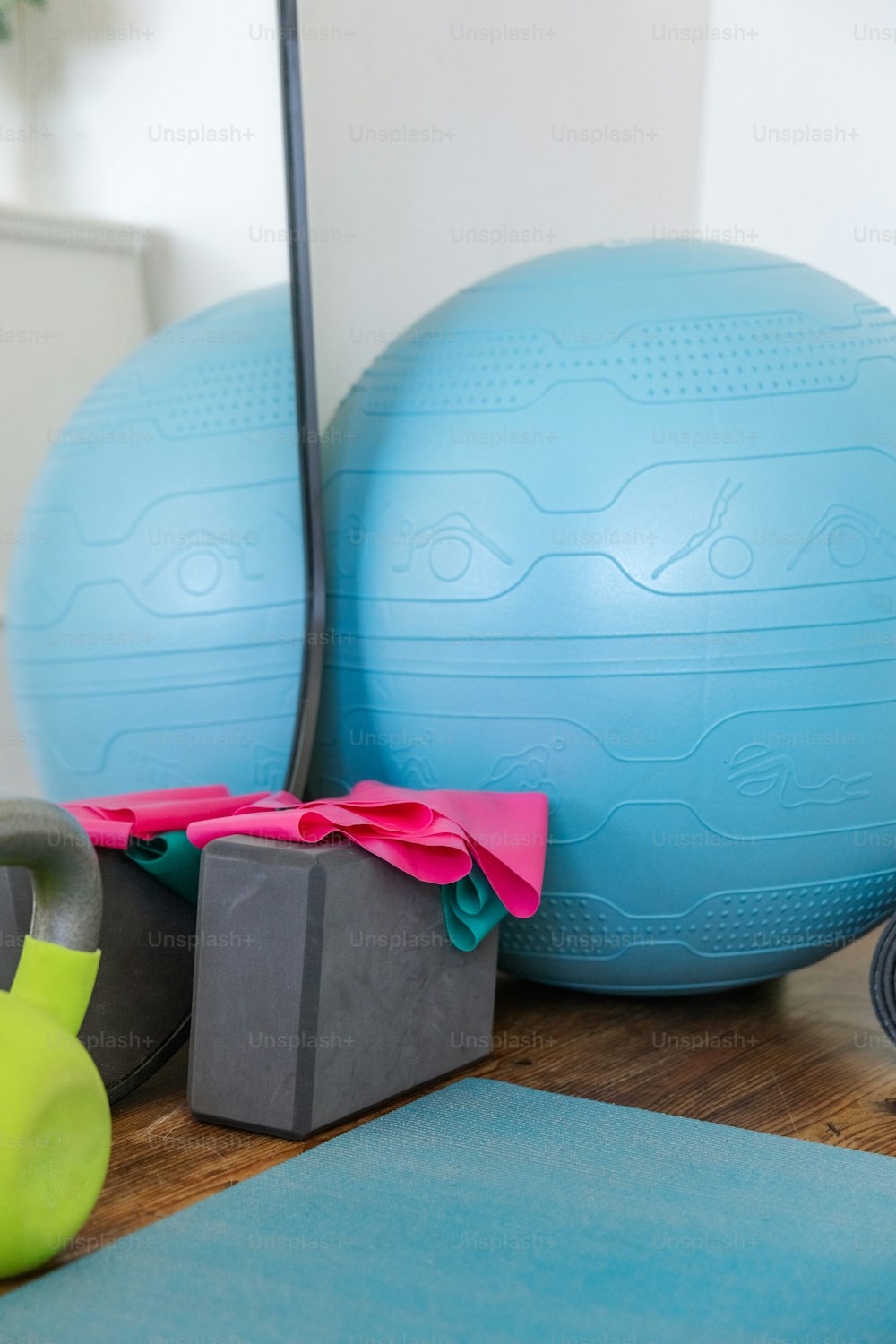 a blue exercise ball sitting on top of a wooden floor