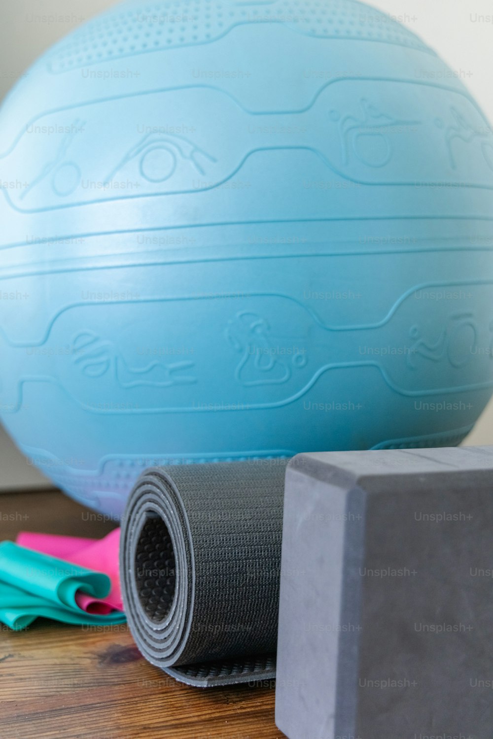 a yoga mat, a block of foam, and a pair of scissors on a