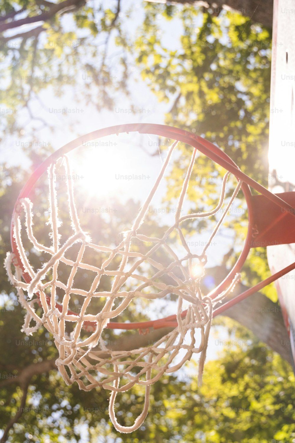 a close up of a basketball going through a hoop