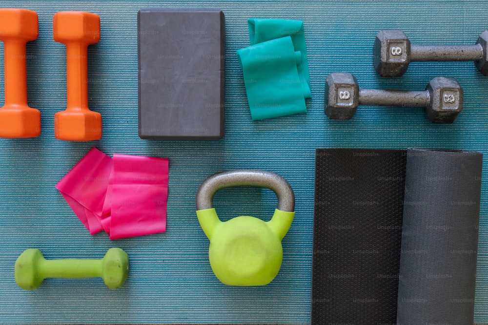 a variety of exercise equipment laid out on a mat