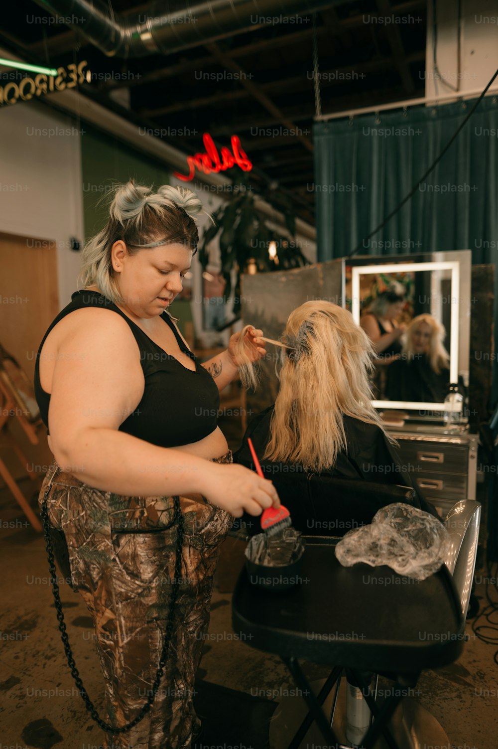 a woman cutting a dog's hair in a salon