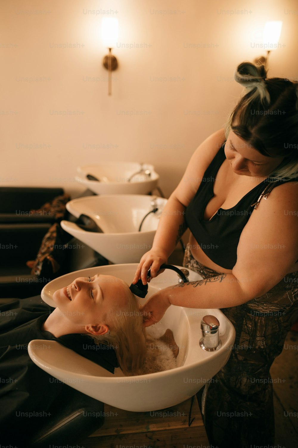 a woman getting her hair cut in a salon