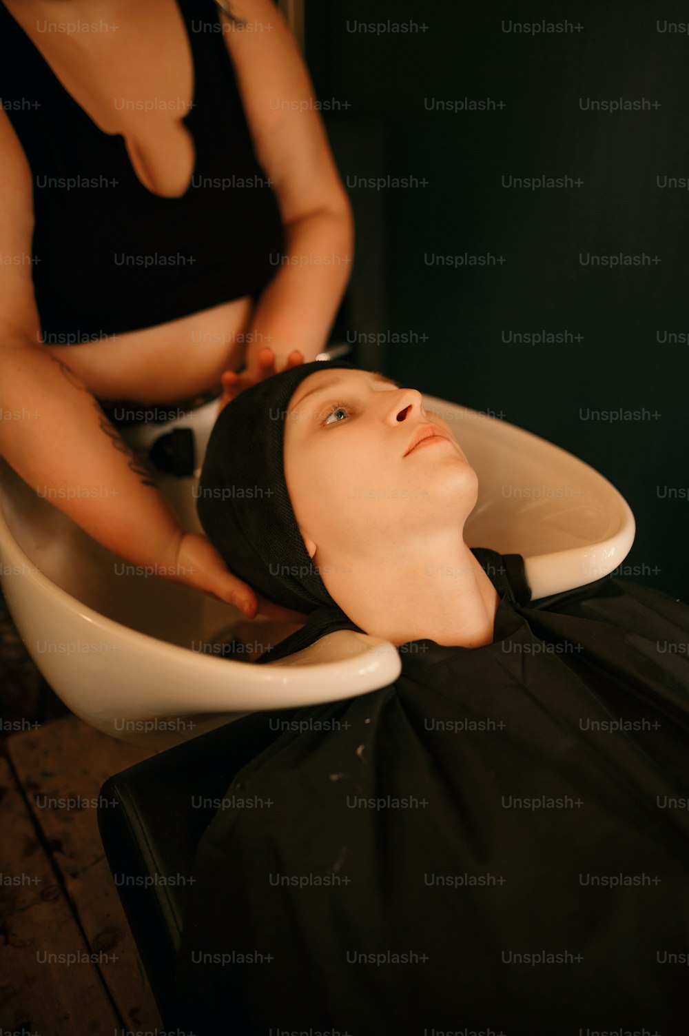 a woman getting her hair washed in a salon