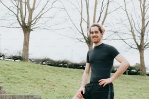 a man in a black shirt is standing on some steps