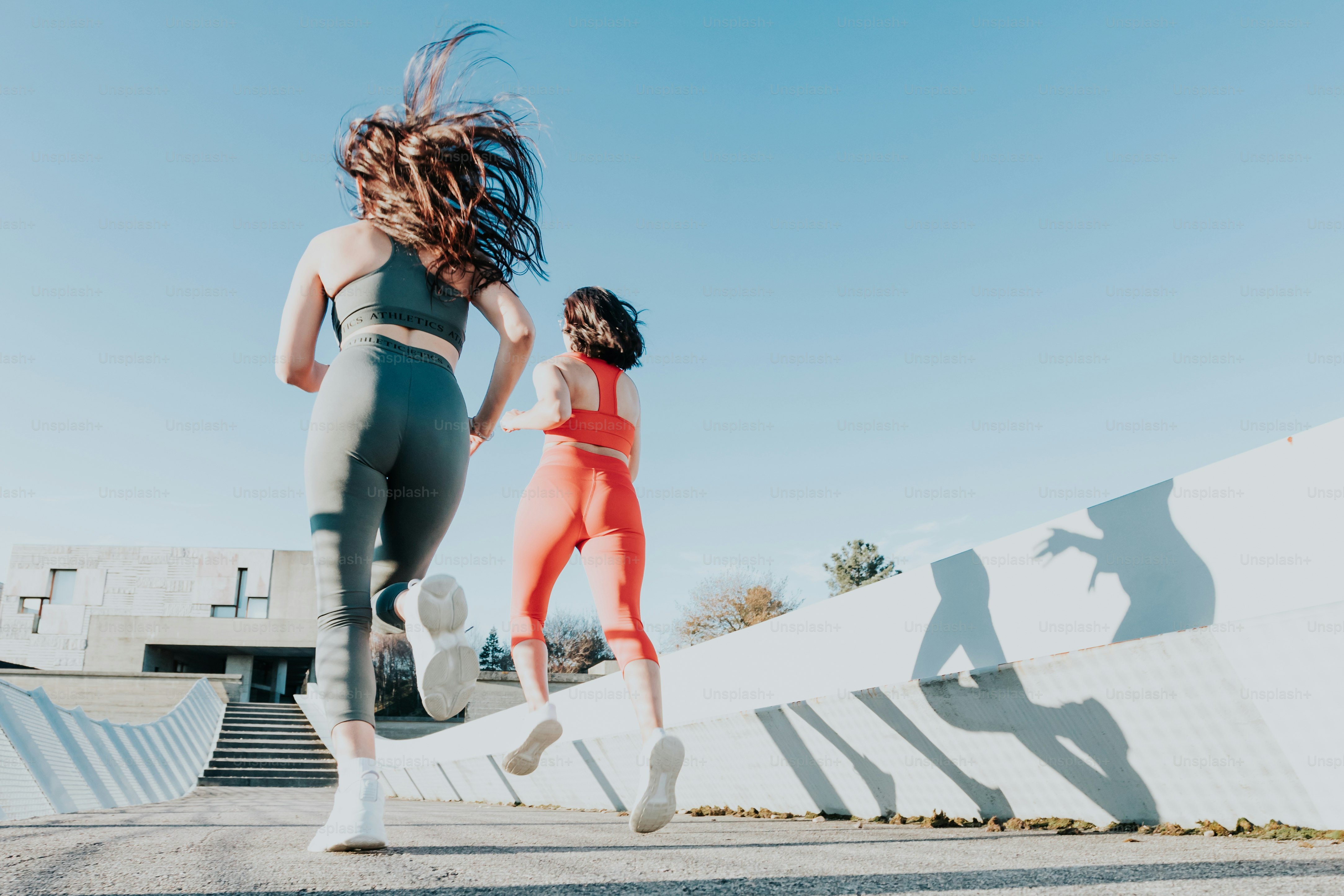 a couple of women running down a street
