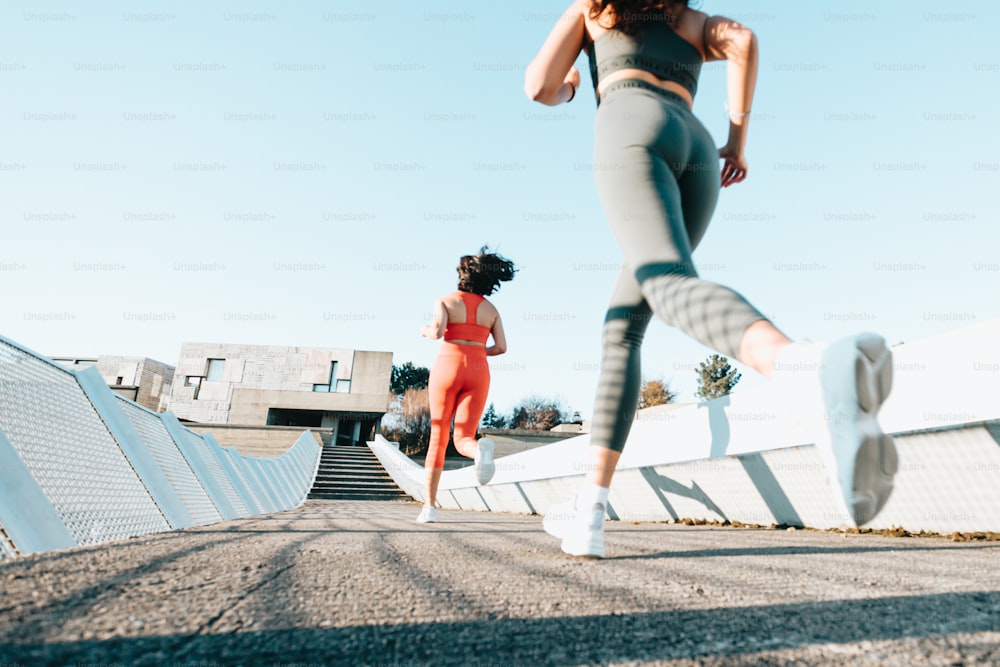 a couple of women running down a road