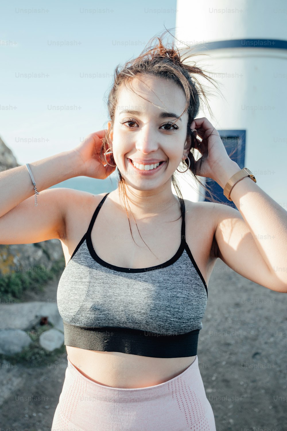 a woman in a gray and black sports bra top