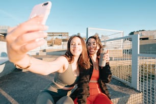 two women taking a selfie with a cell phone