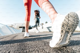 a woman walking down a street next to another woman