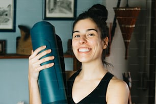 a woman holding a large blue object in her hands