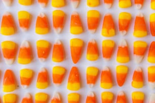 a close up of candy corn on a white surface