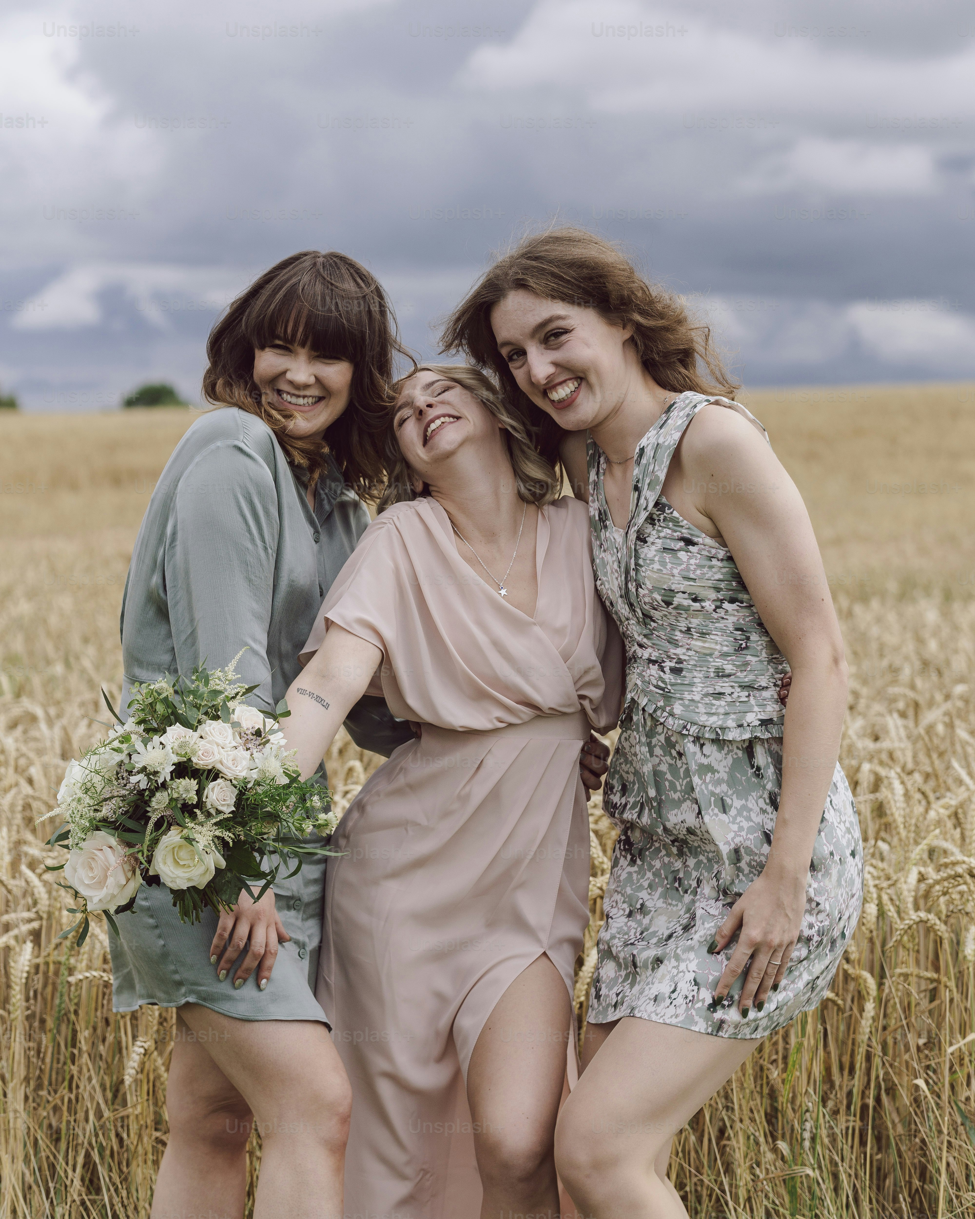 a group of women standing next to each other in a field