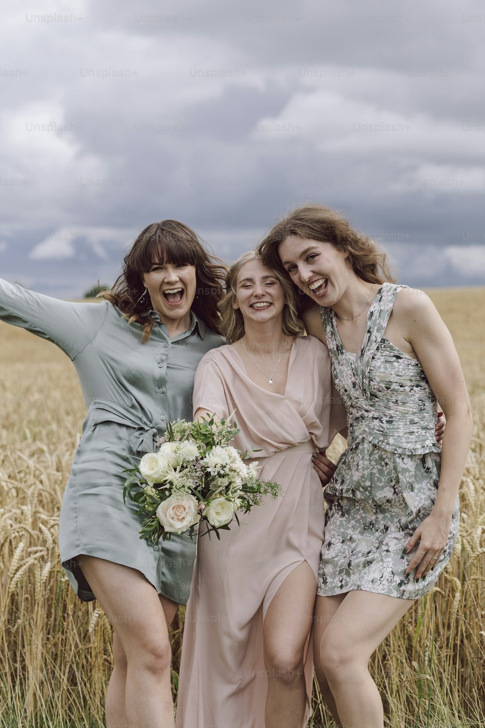 a group of women standing next to each other in a field