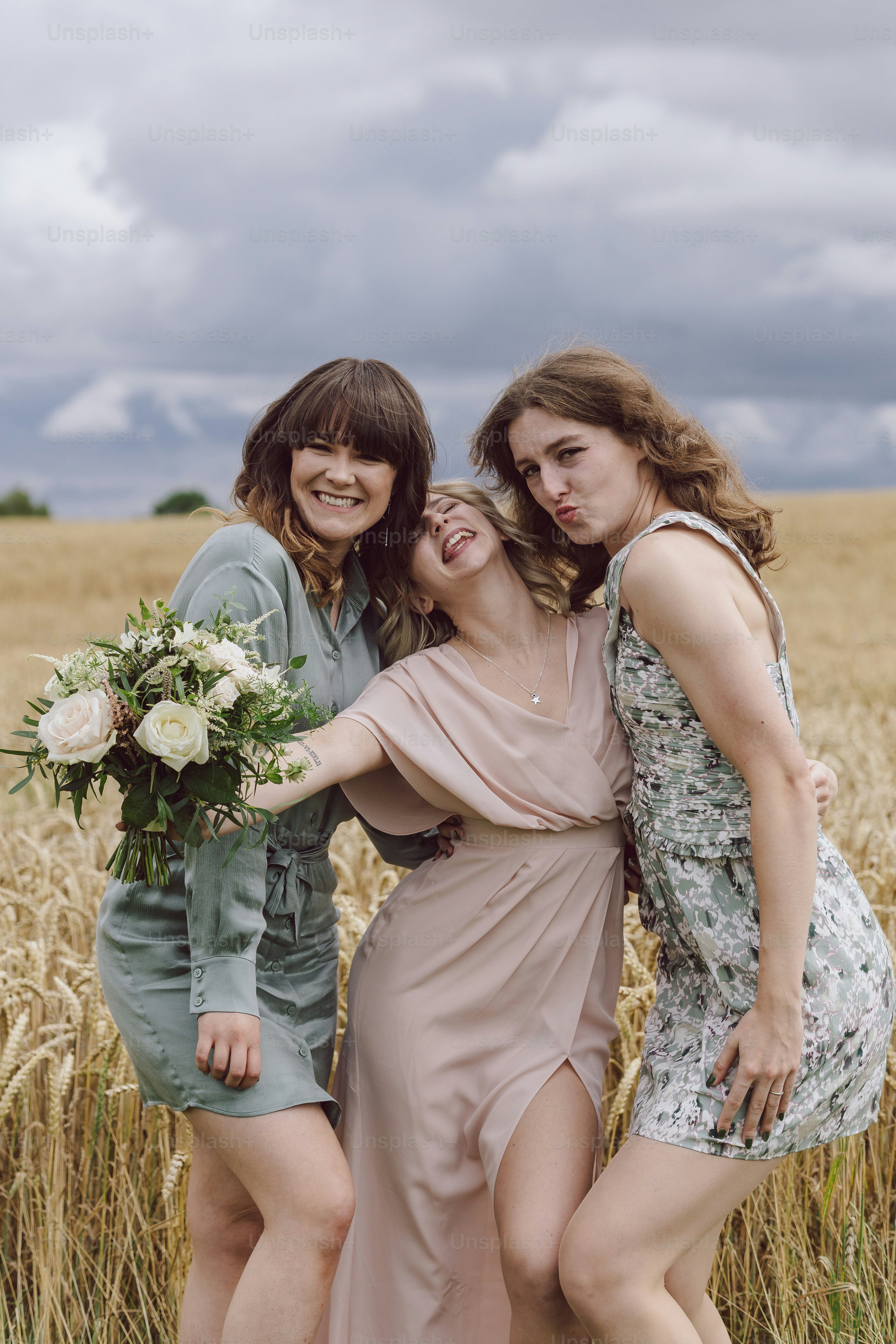 A group of women standing next to each other in a field photo – Wedding ...