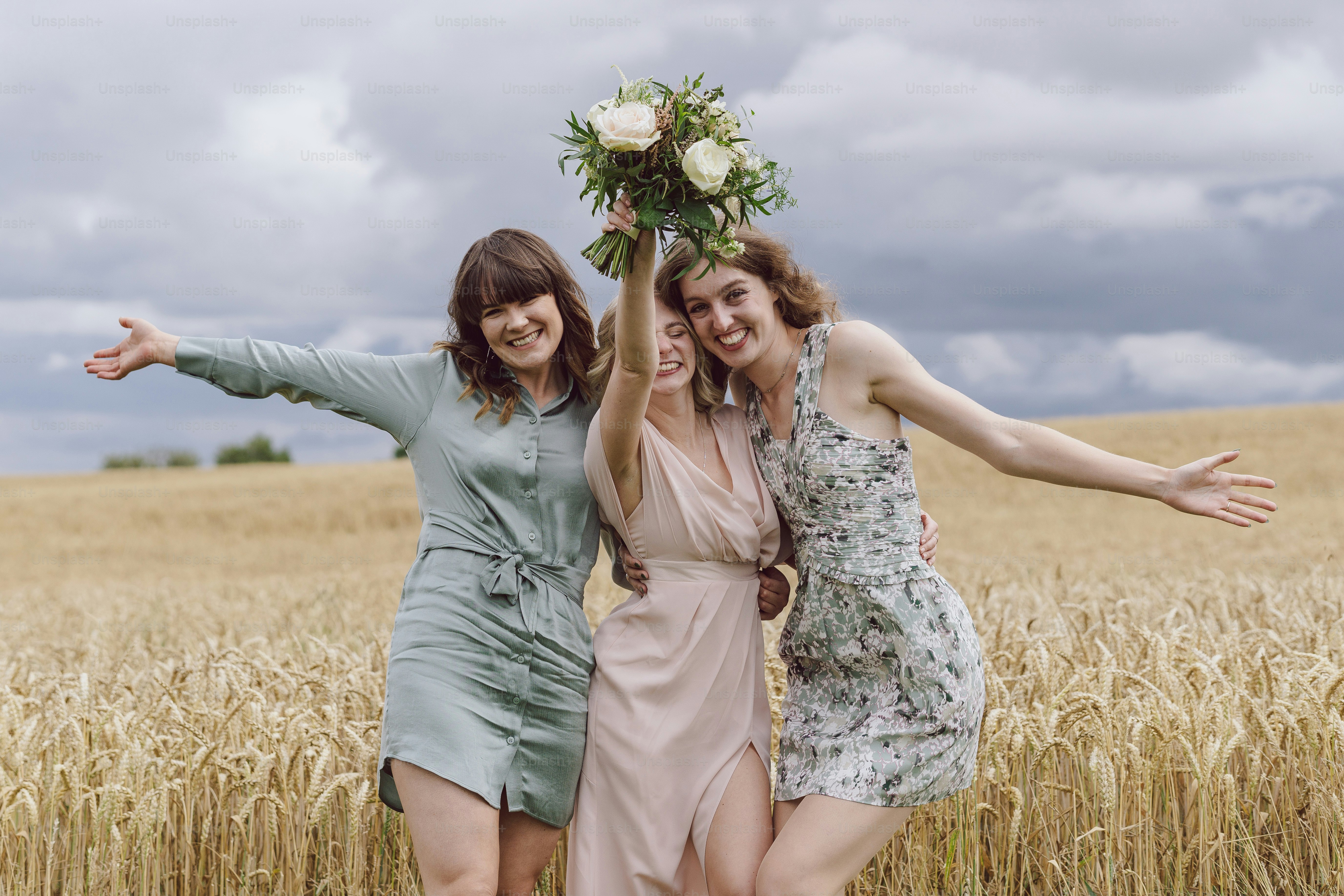 a group of women standing next to each other in a field