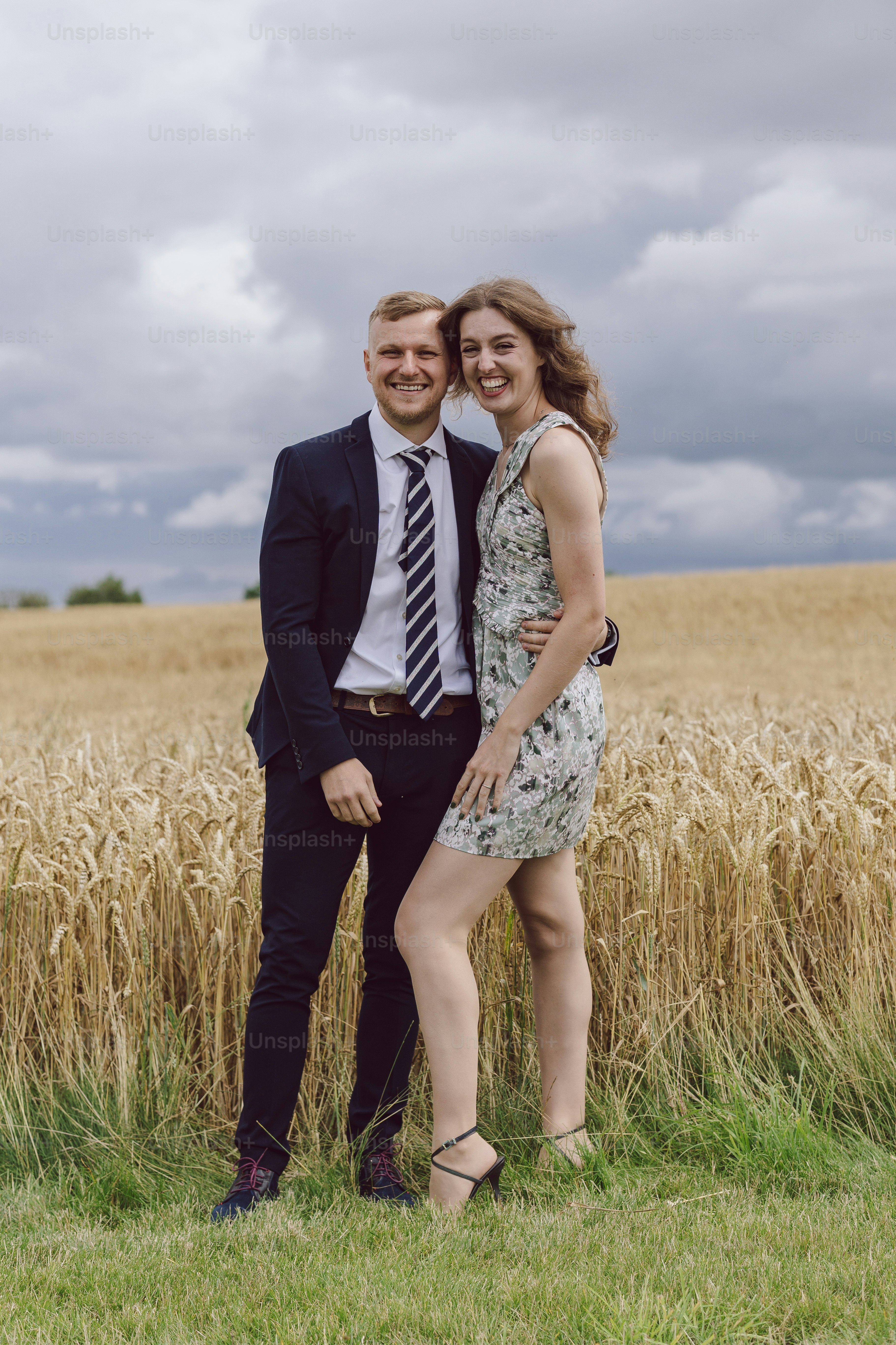 a man and a woman standing in a field
