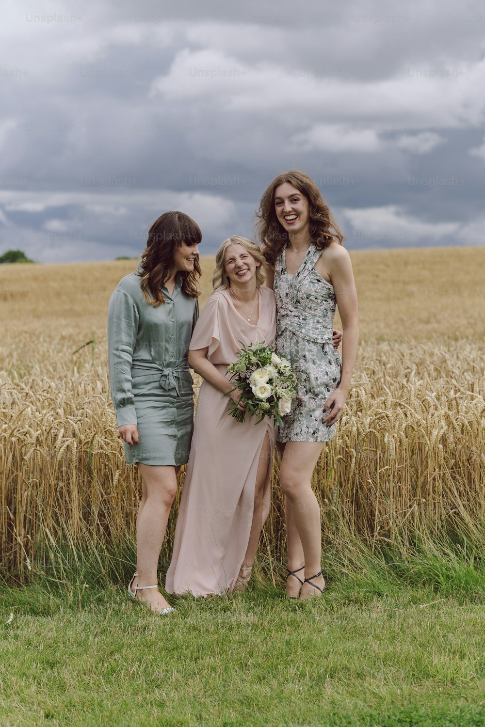 a group of women standing next to each other in a field