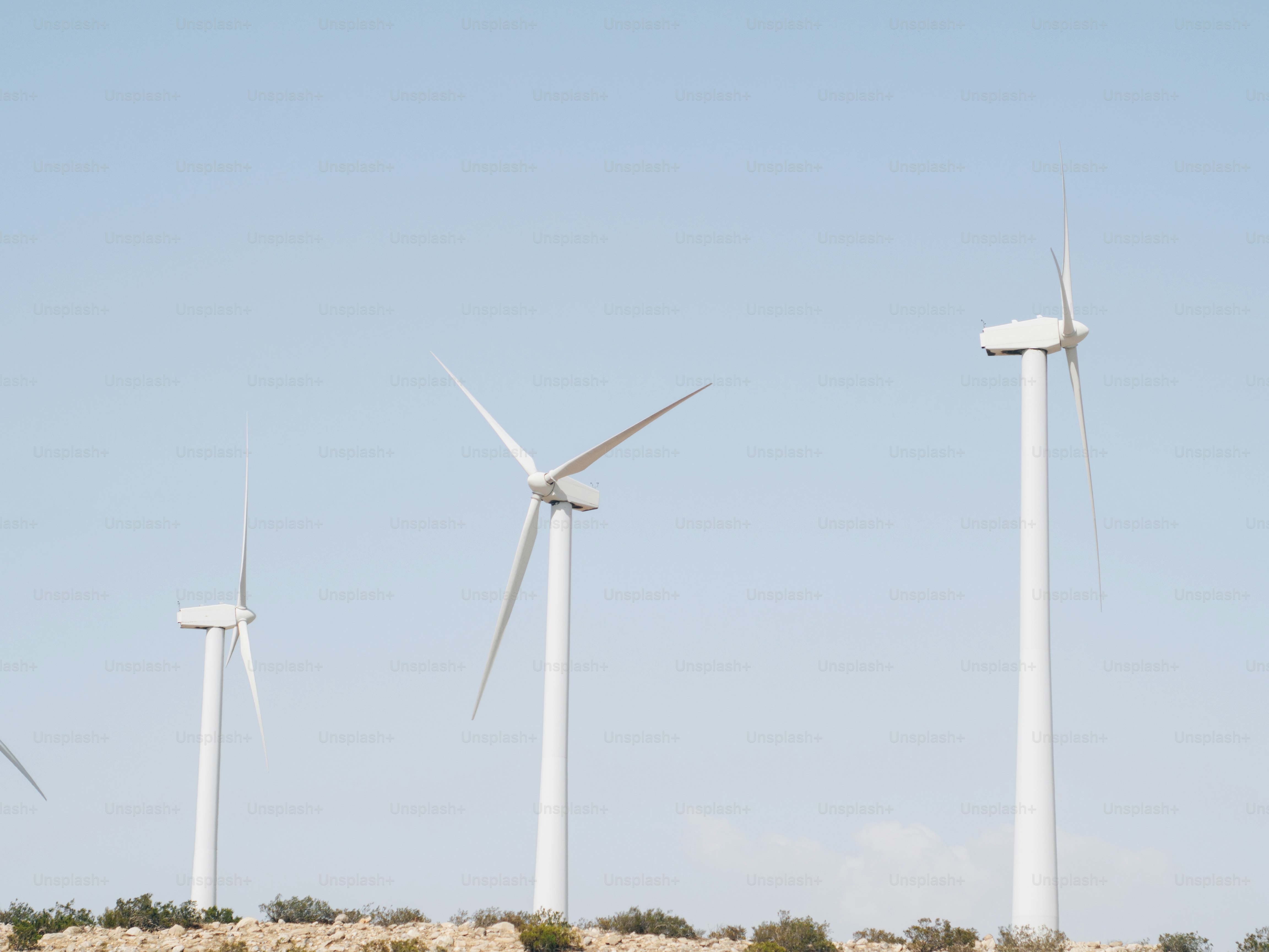 A group of wind turbines on a hill photo – Wind farm Image on Unsplash