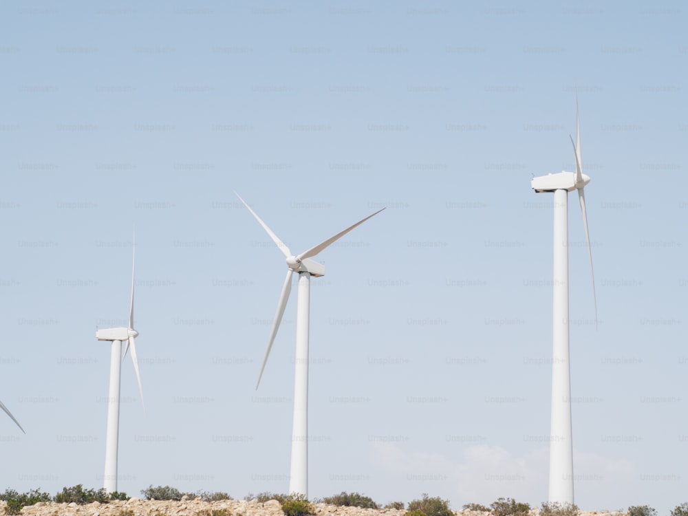 a group of wind turbines on a hill