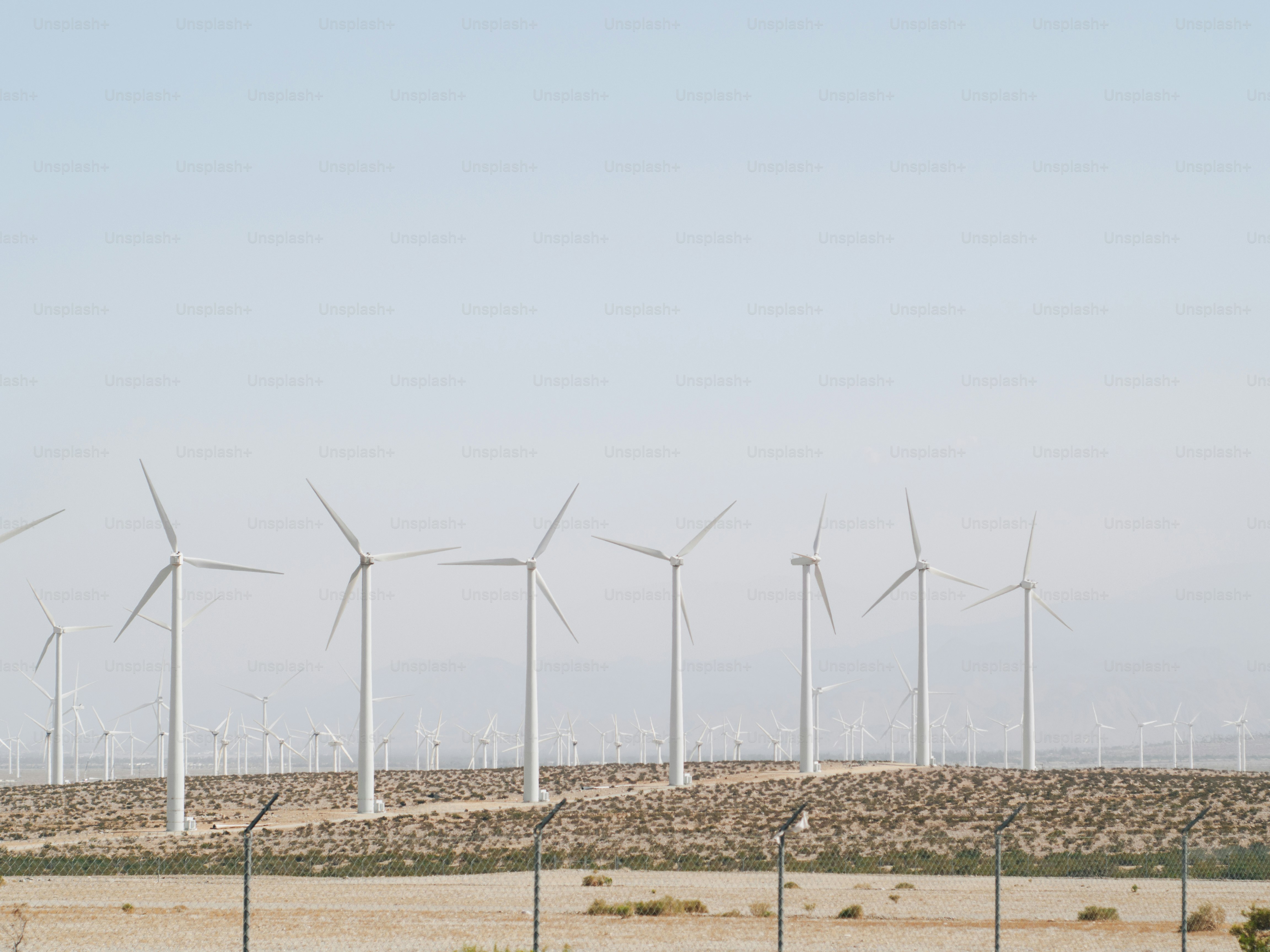 A group of wind turbines on a hill photo – Wind farm Image on Unsplash