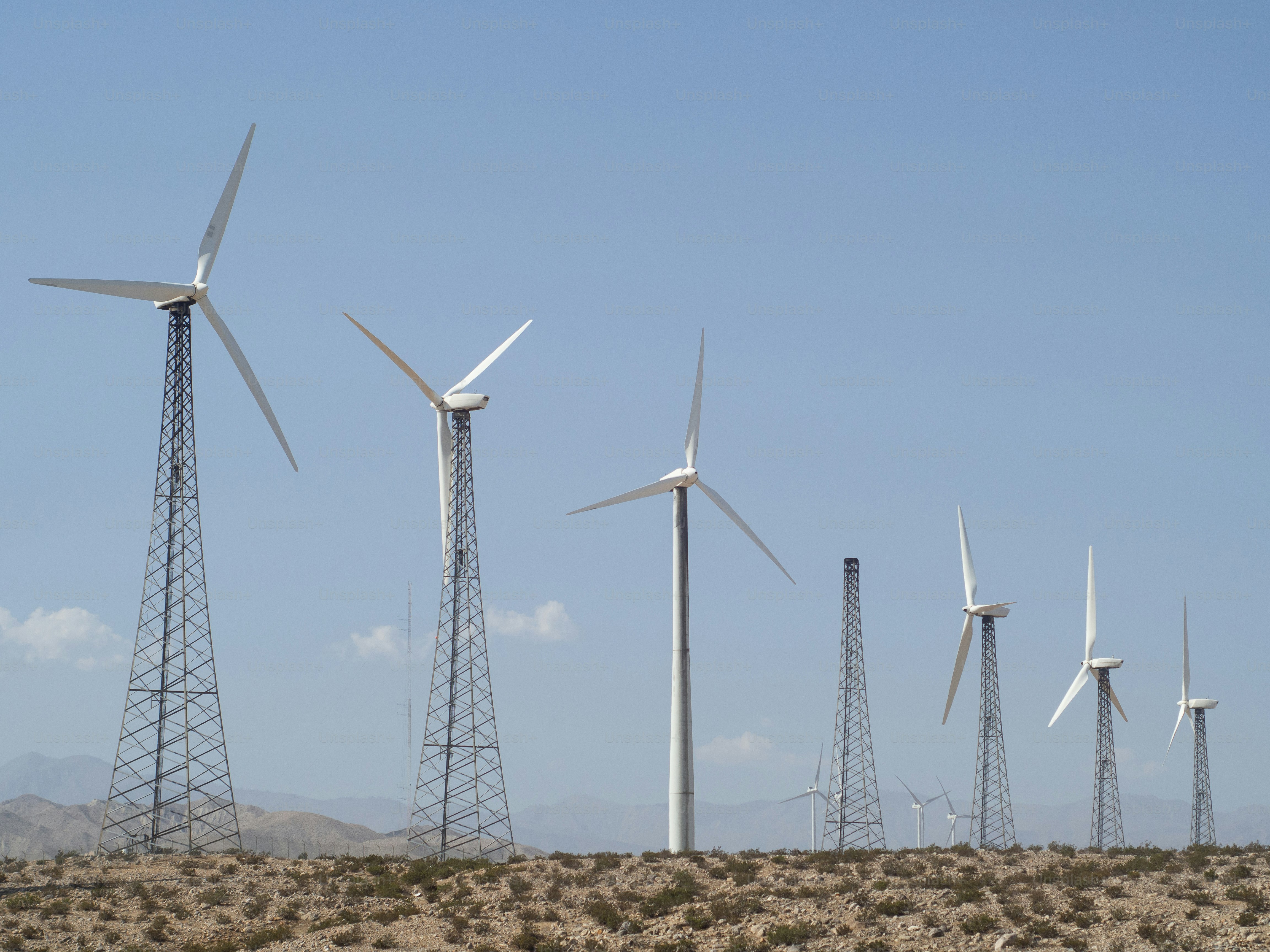 A group of wind turbines on a hill photo – Wind farm Image on Unsplash