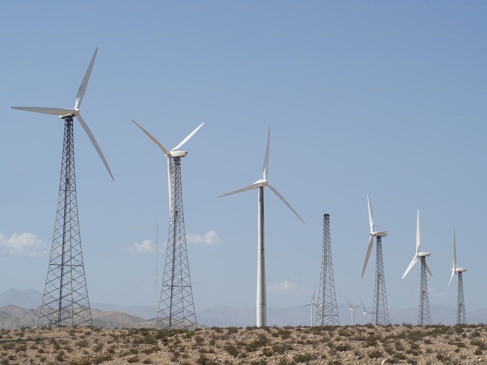 a row of wind turbines in a desert