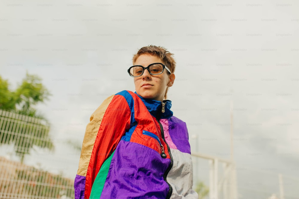 a man wearing a colorful jacket and glasses