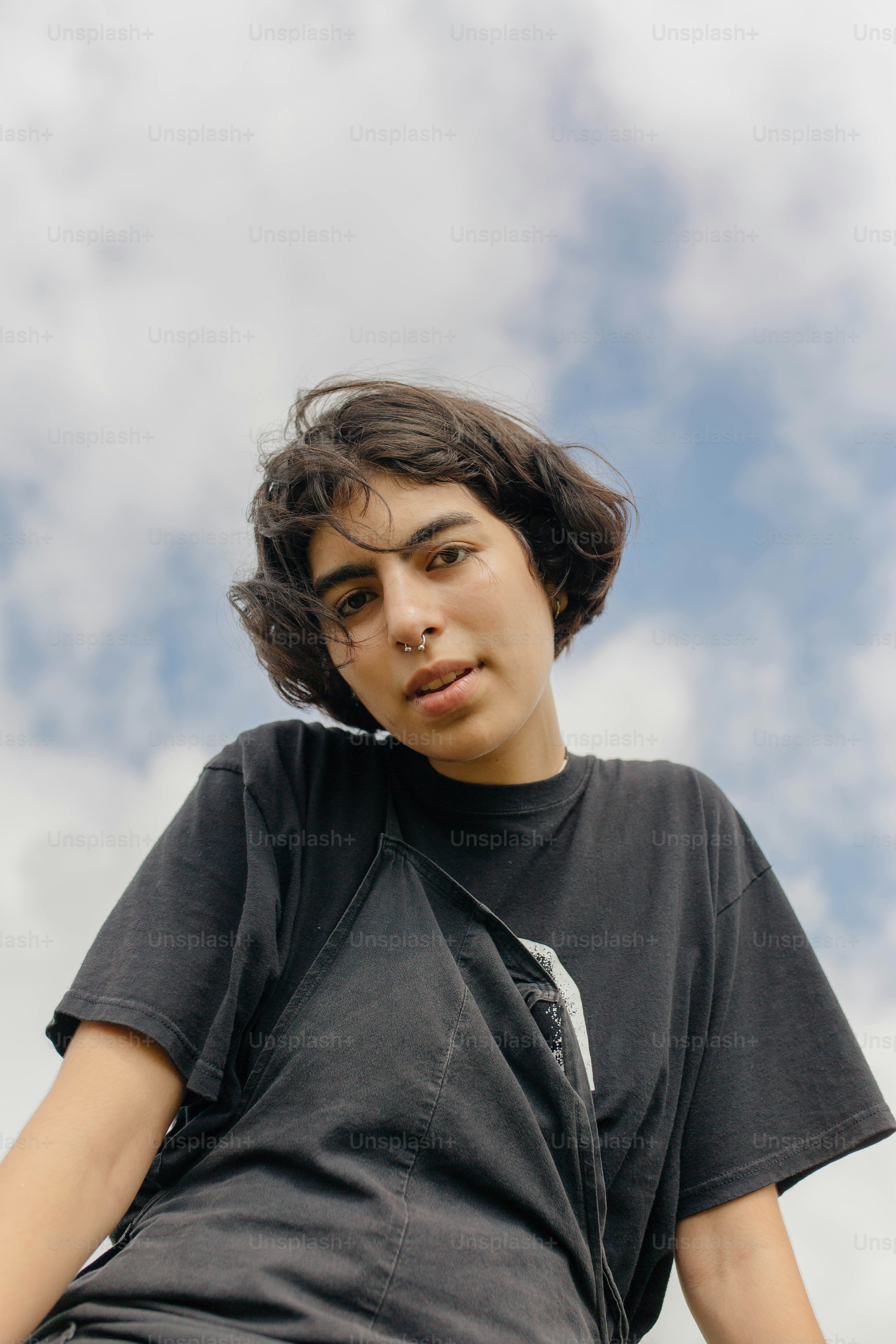a young man sitting on top of a wooden bench