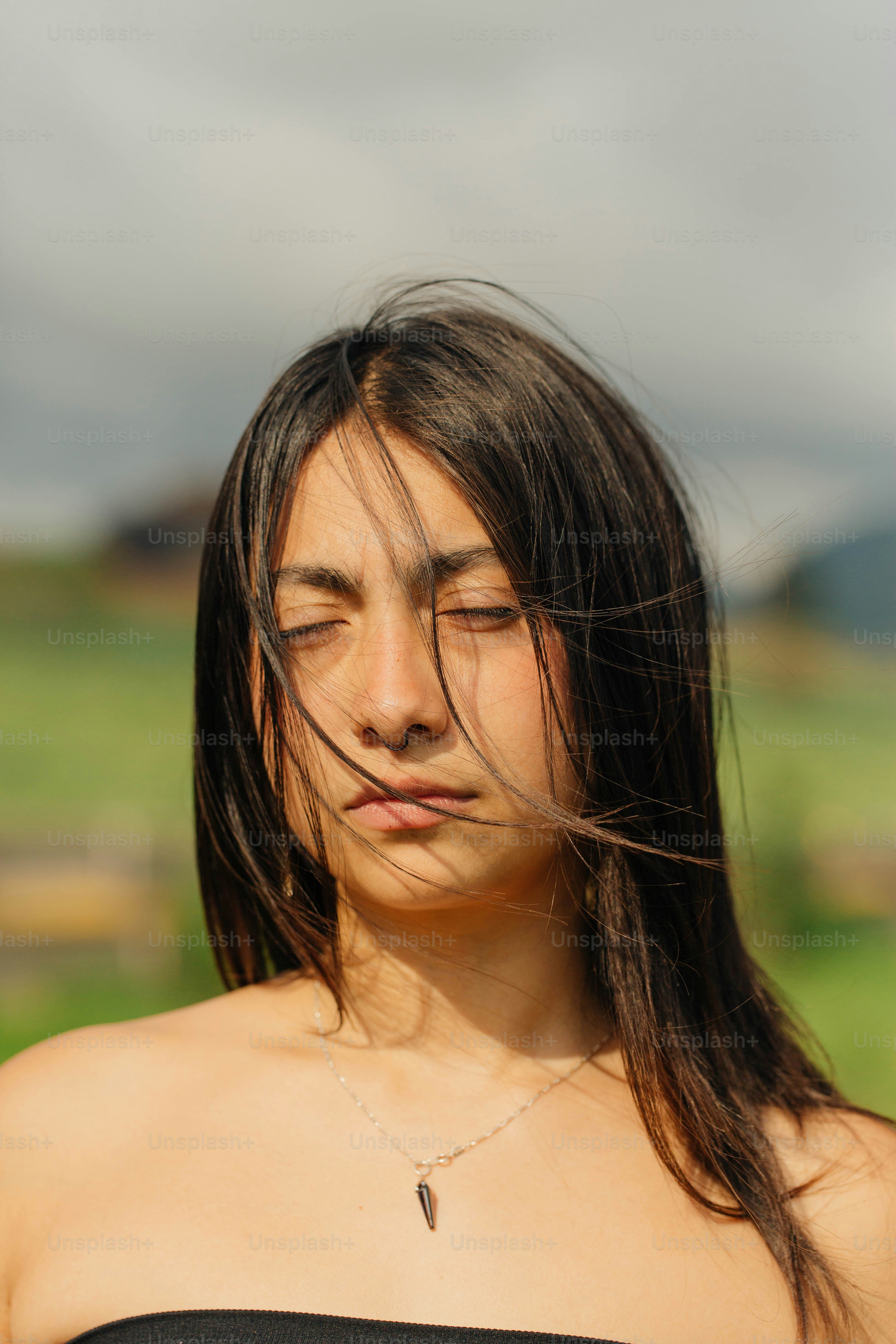 A woman with her eyes closed standing in a field photo – Fashion Image ...