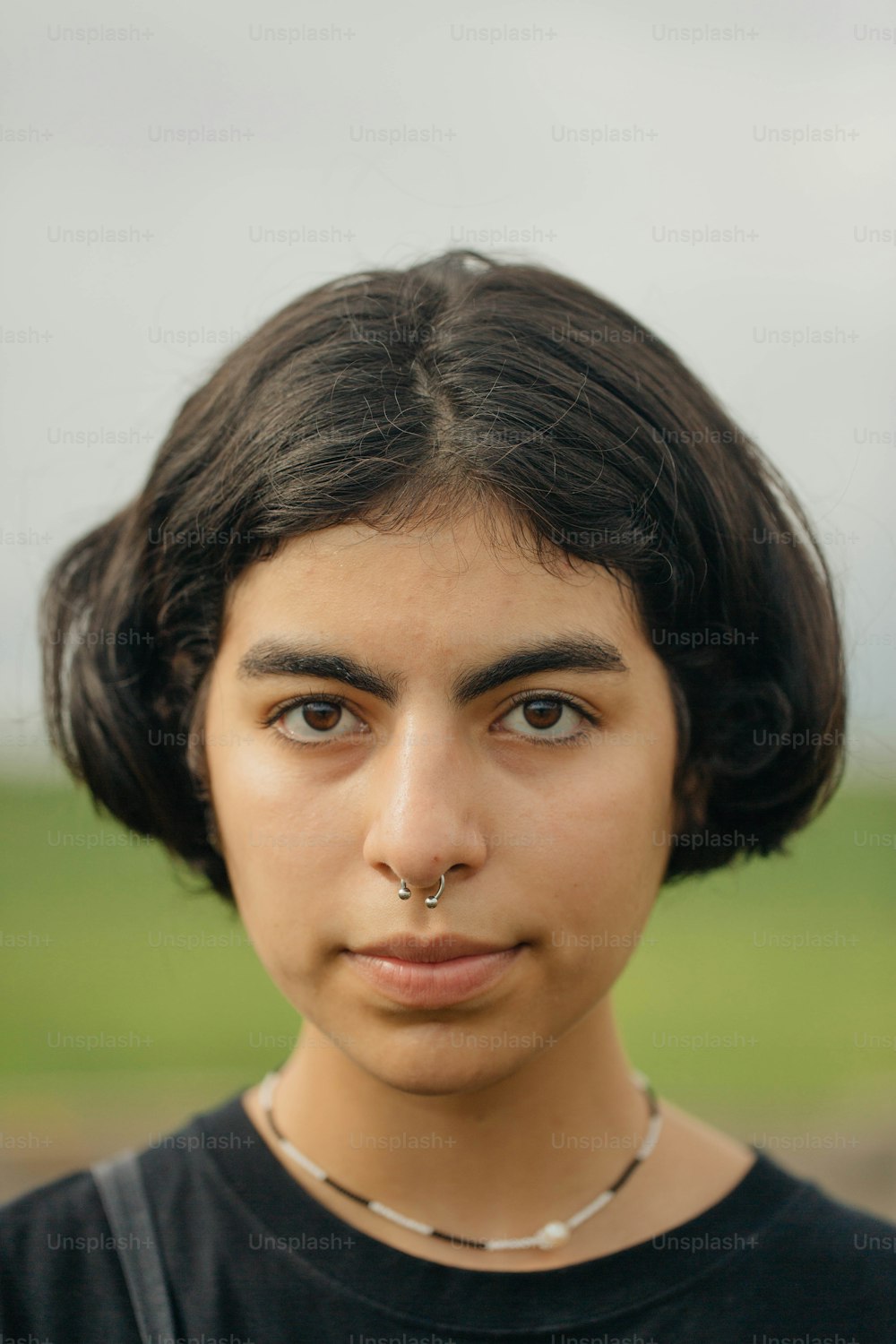 a woman with a nose ring and nose piercing
