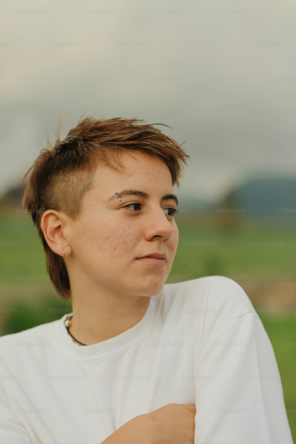 a woman with short hair and a white shirt
