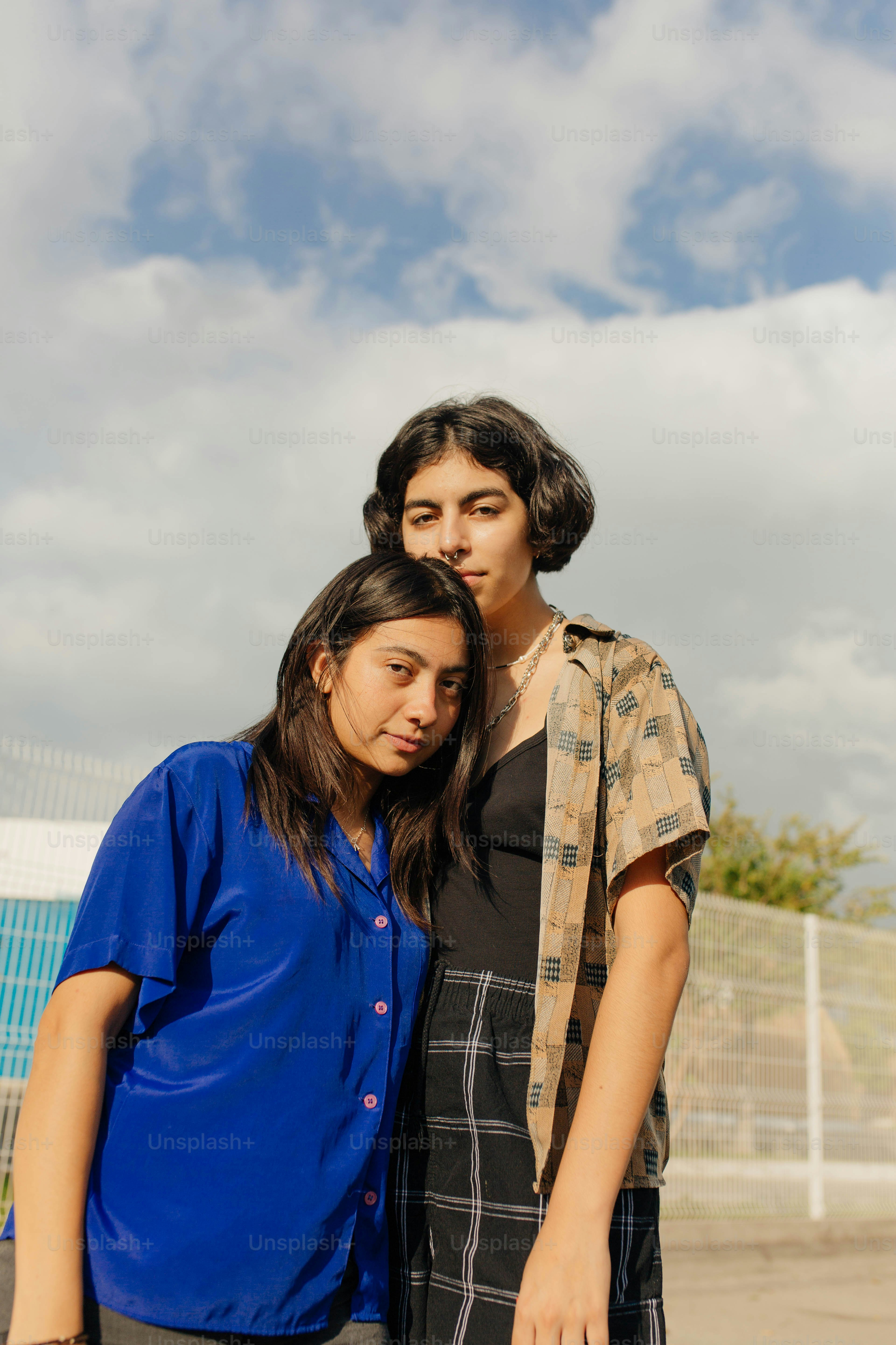 A couple of people standing next to each other photo – Outdoor Image on ...