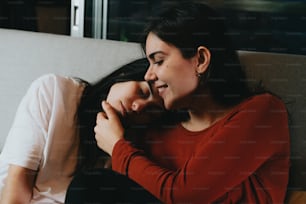 a couple of women sitting next to each other on a couch