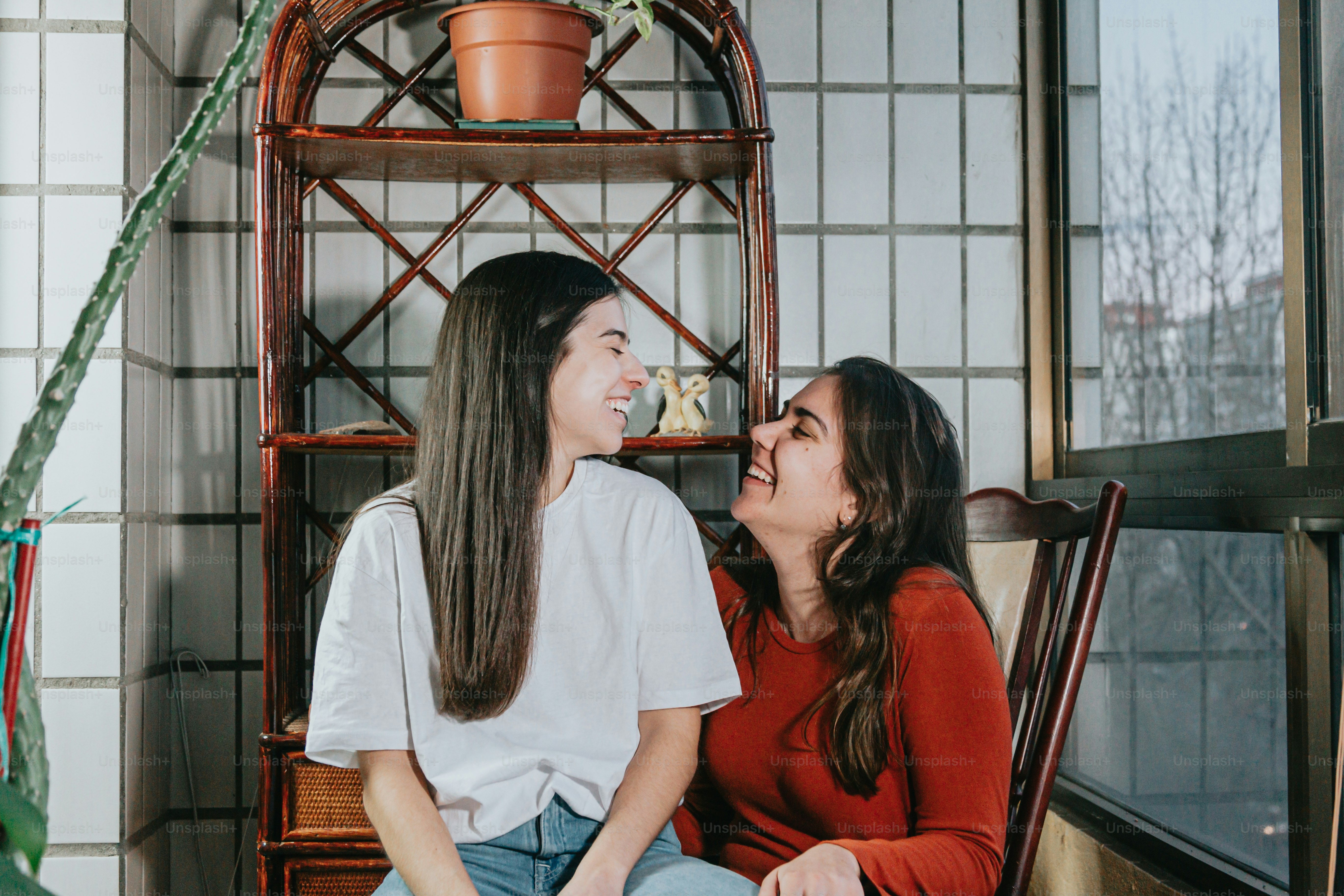 a couple of women sitting next to each other
