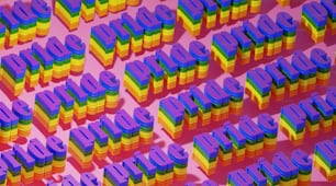 a large number of colorful letters on a pink background