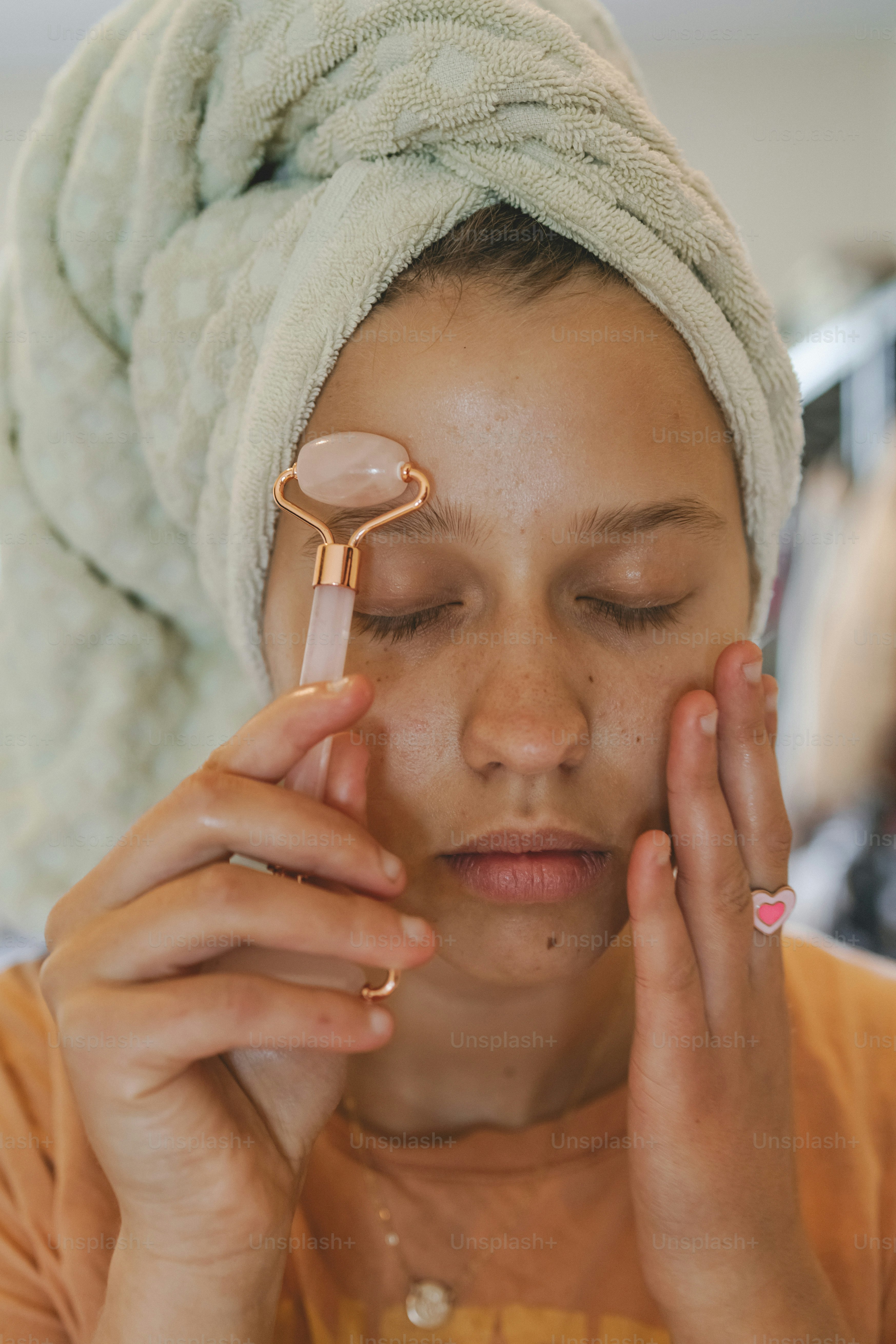 eine Frau mit einem Handtuch auf dem Kopf und einem Fön auf dem Kopf