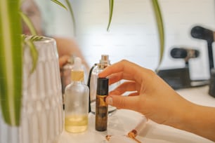 a person holding a small bottle of essential oils