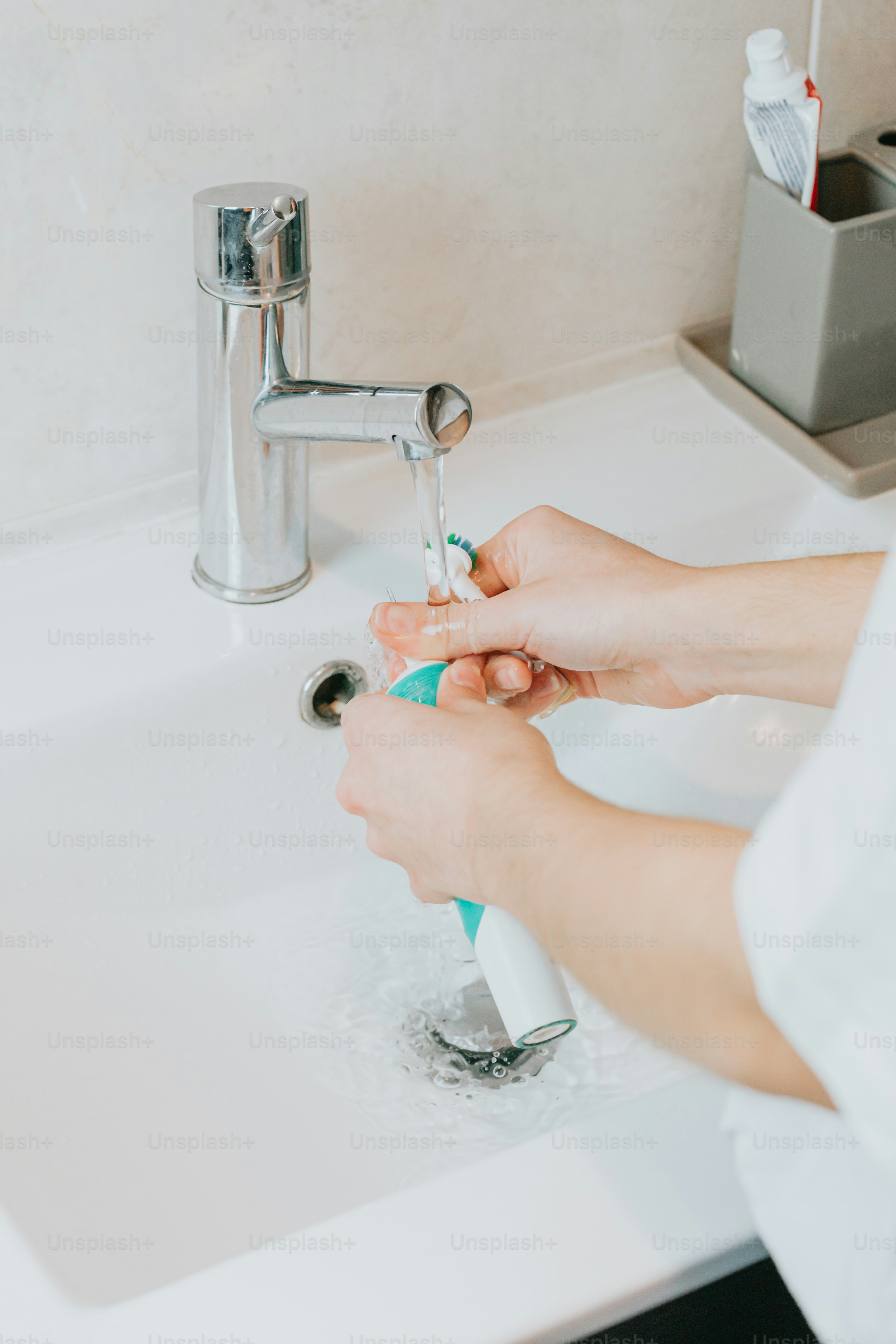 a person is washing their hands in a sink