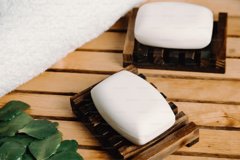 a couple of soaps sitting on top of a wooden tray