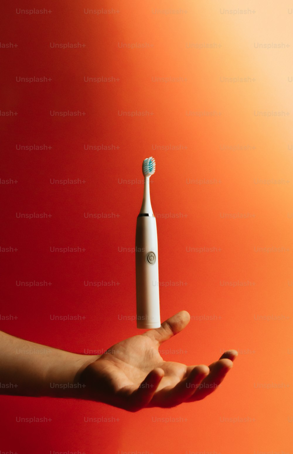 a person holding a toothbrush in their hand