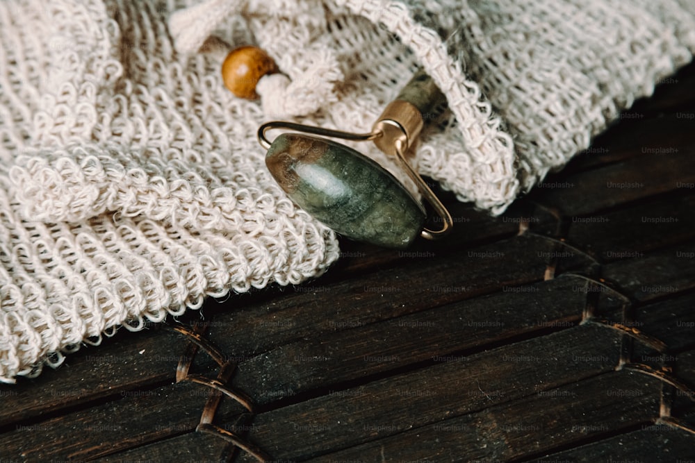 a white sweater with a wooden bead on it