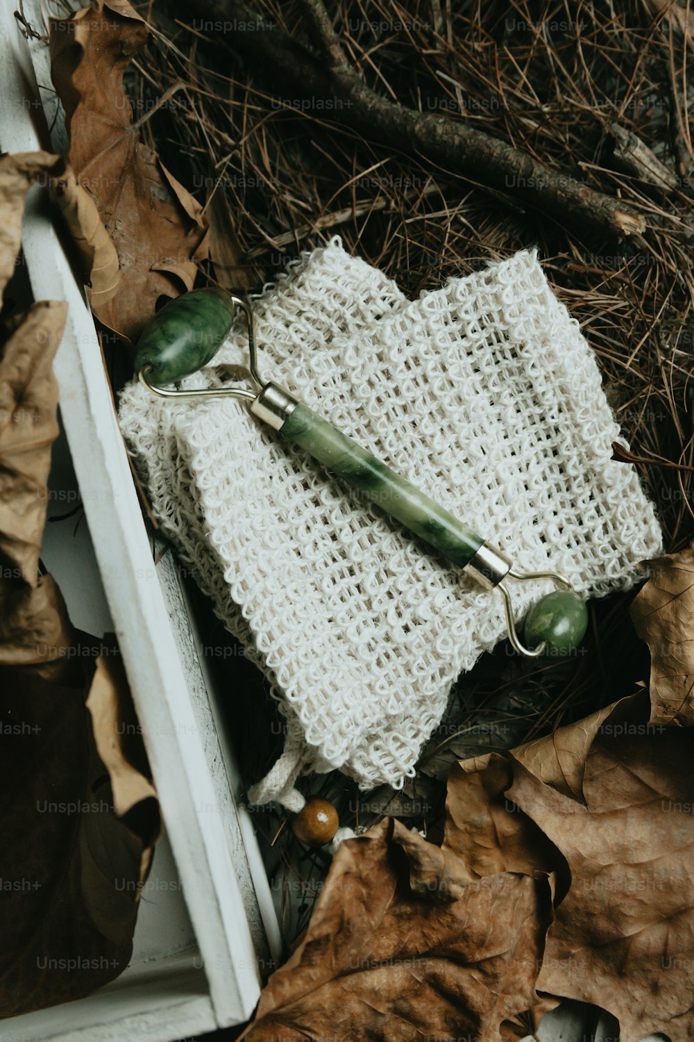 a pair of scissors laying on top of a knitted object