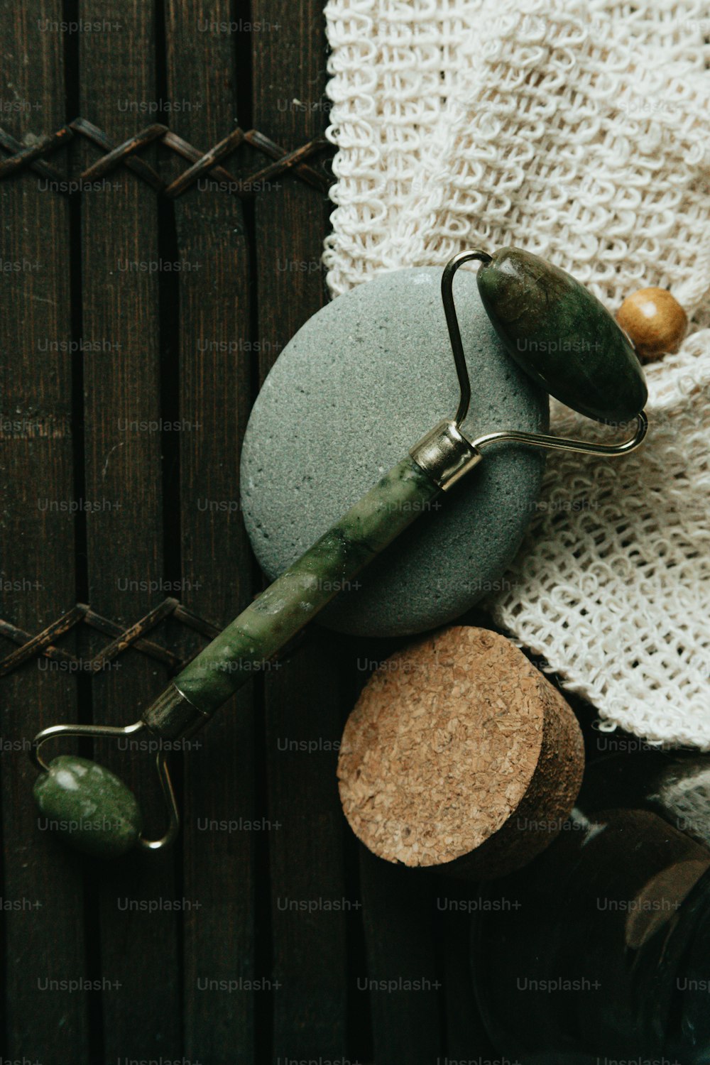 a green stone with a fishing hook on top of it